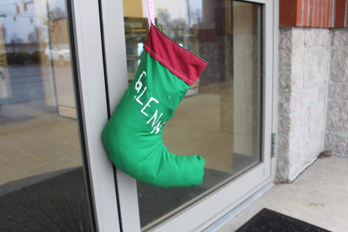 A coal-stuffed stocking with “Glenn” painted on it hangs on the door of U.S. Rep. Glenn “GT” Thompson’s Bellefonte office after a Tuesday protest.