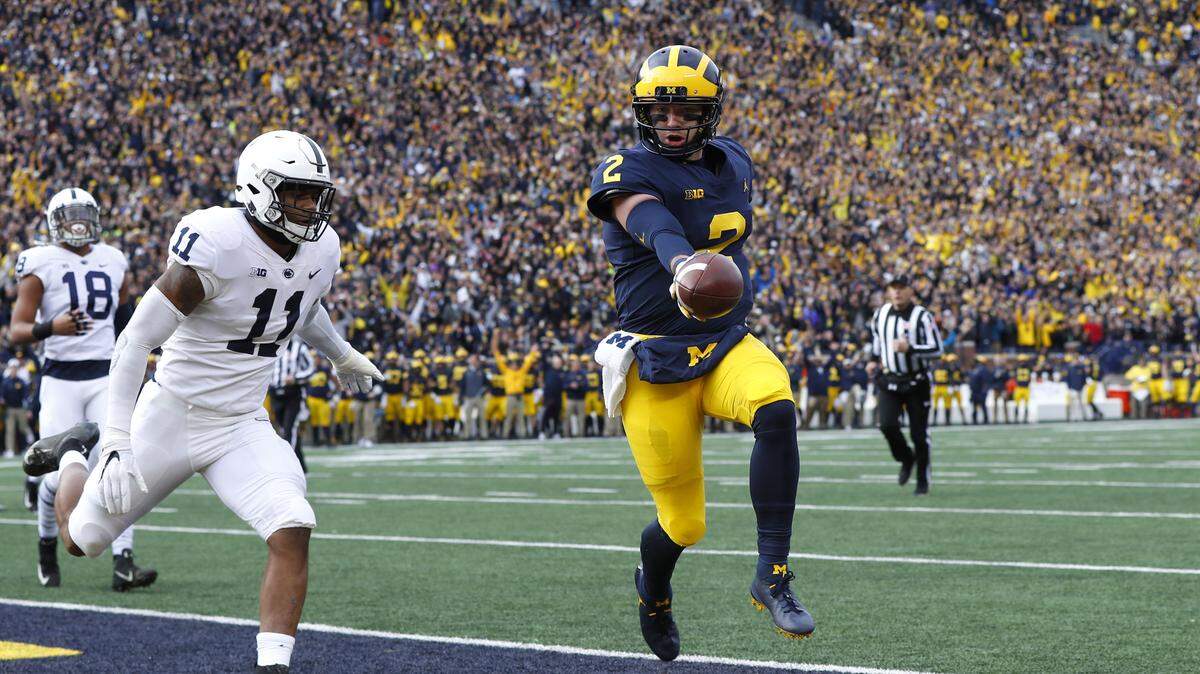 Michigan quarterback Shea Patterson (2) scores on a one-yard touchdown run as Penn State linebacker Micah Parsons (11) defends in the first half of an NCAA college football game in Ann Arbor, Mich., Saturday, Nov. 3, 2018. (AP Photo/Paul Sancya)
