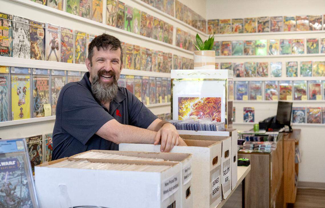 Justin Behrens laughs as he talks about comic books at his shop Comic Cove on Monday, May 20, 2024.