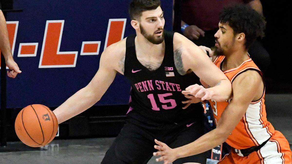 Penn State forward Trent Buttrick (15) controls the ball as Illinois guard Jacob Grandison defends during the first half of an NCAA college basketball game Tuesday, Jan. 19, 2021, in Champaign, Ill.