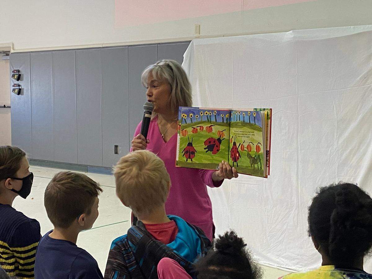 Kim Resh, founder of Mikayla’s Voice, reads “The Spot” by Holden Frye, to students at Young Scholars on April 29.