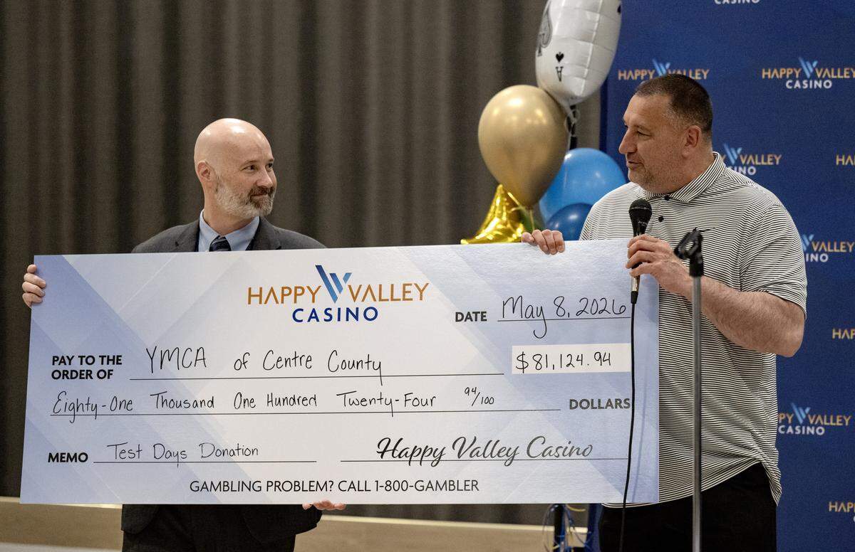 General manager of Happy Valley Casino Eric Pearson presents a check to Scott Mitchell from the YMCA of Centre County during a ribbon cutting for the Happy Valley Casino on Friday, May 8, 2026. Money that was brought in on the test days of the casino were split between the YMCA of Centre County and the State College Food Bank.  