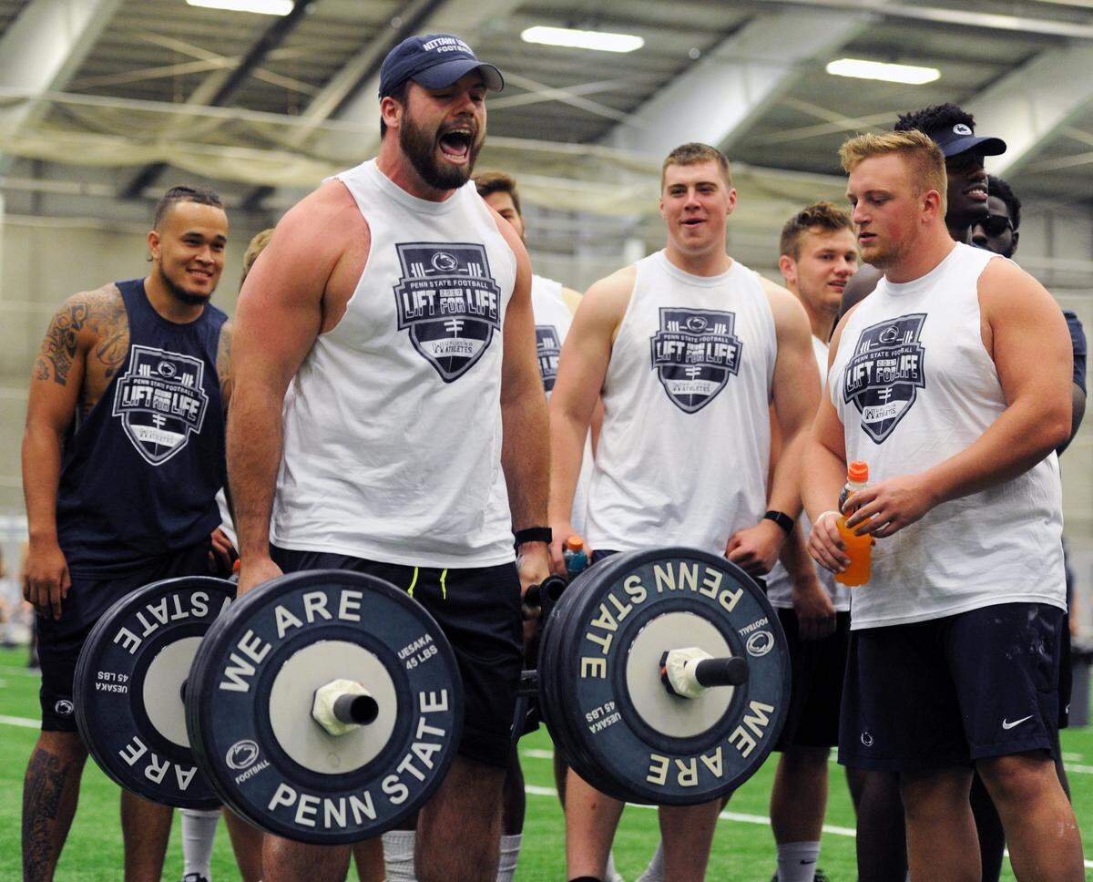 Penn State offensive lineman Michal Menet participates in a weight competition during Lift for Life Saturday, July 15, 2017 at Holuba Hall.