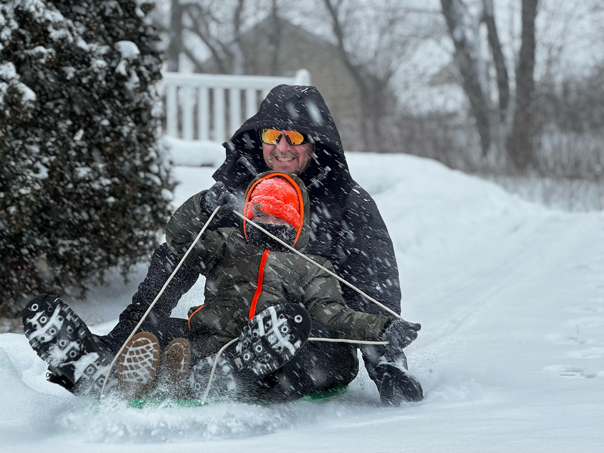 River Lumadue, 6, and his father Jeremy, both of Philipsburg, sled down Dale Shoffner’s driveway in South Philipsburg on Sunday.