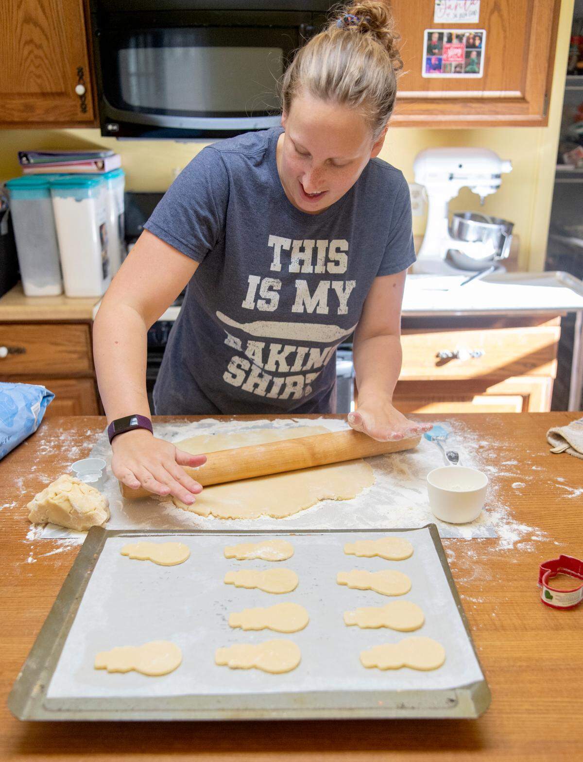 Christina Hallett of Crumbkowski rolls the dough to cut more sugar cookies for holiday orders on Monday.