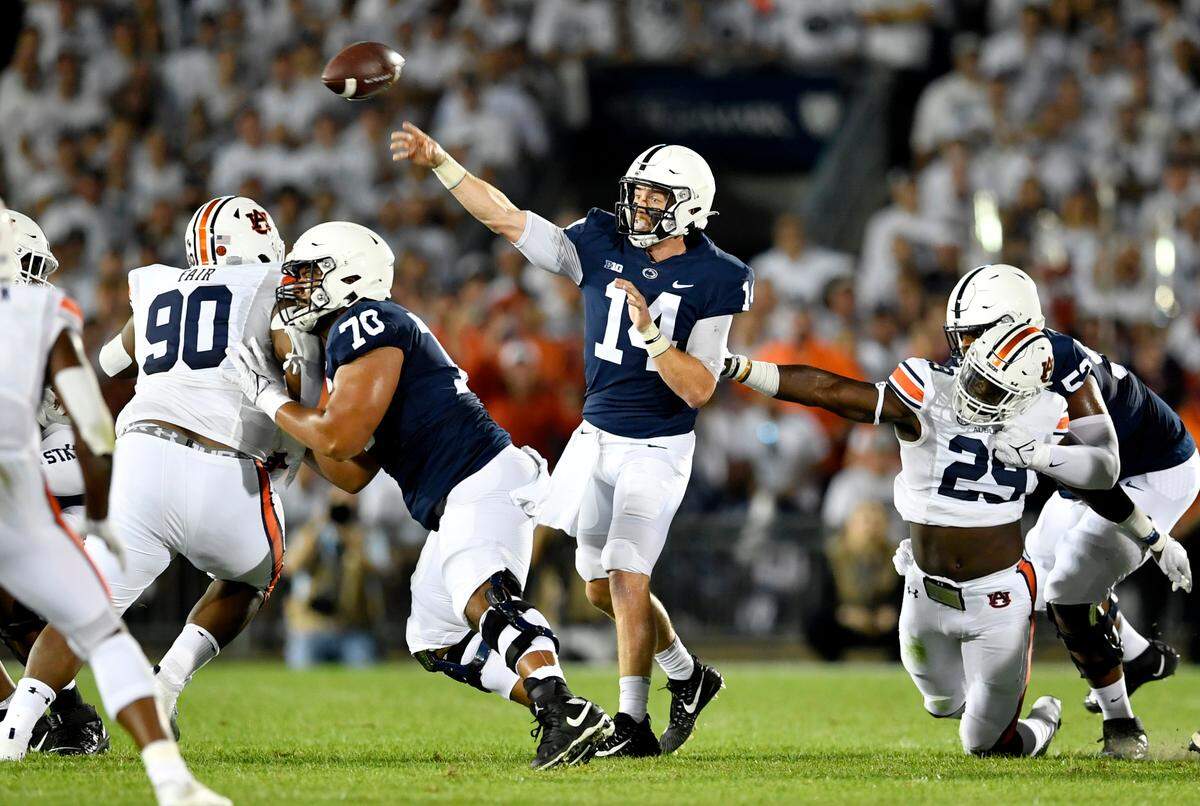 Penn State offensive lineman Juice Scruggs blocks AuburnÕs Tony Fair as quarterback Sean Clifford makes a pass during the game on Saturday, Sept. 18, 2021.