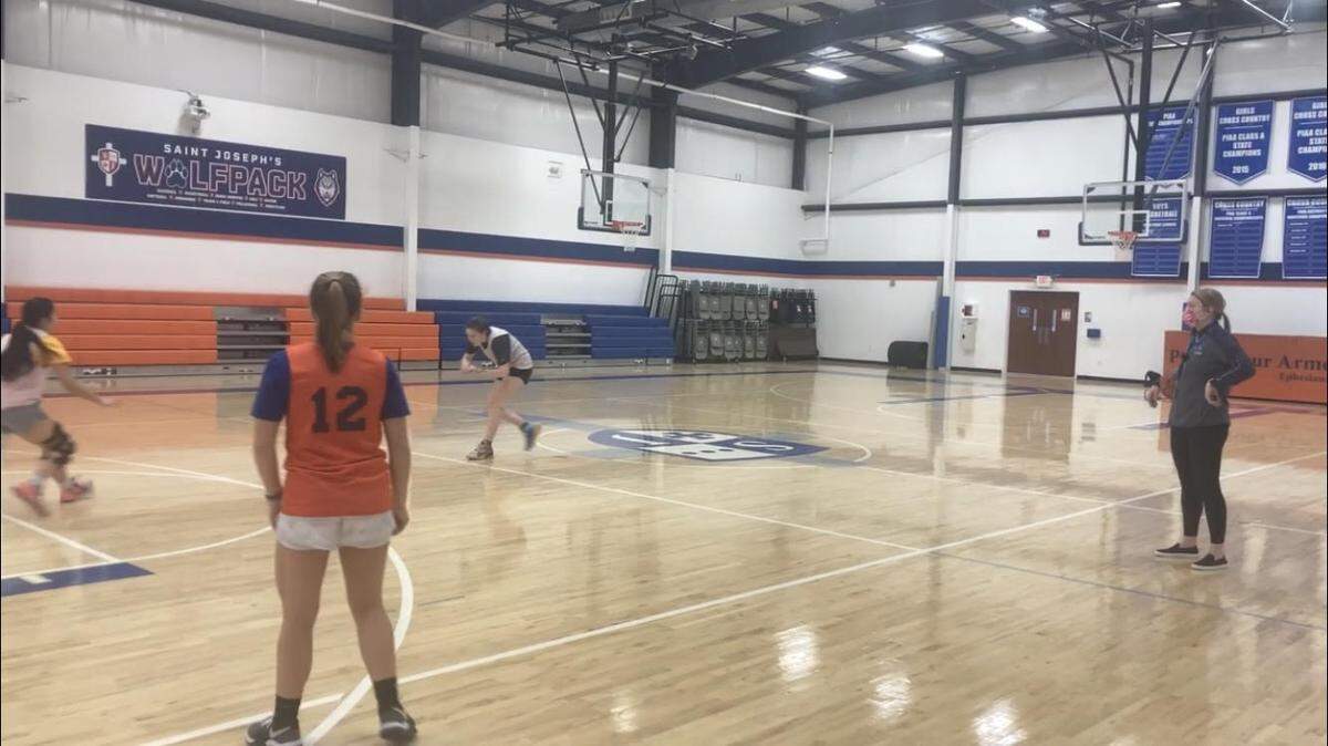 Saint Joseph Catholic Academy girls basketball head coach Katei Sosnoskie (right) watches over her team’s practice on January 19, 2022.