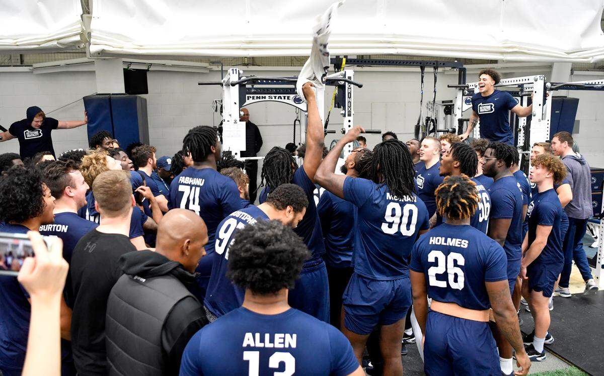 Penn State football players cheer on their teammates during a weight lifting session on Thursday, March 3, 2022.