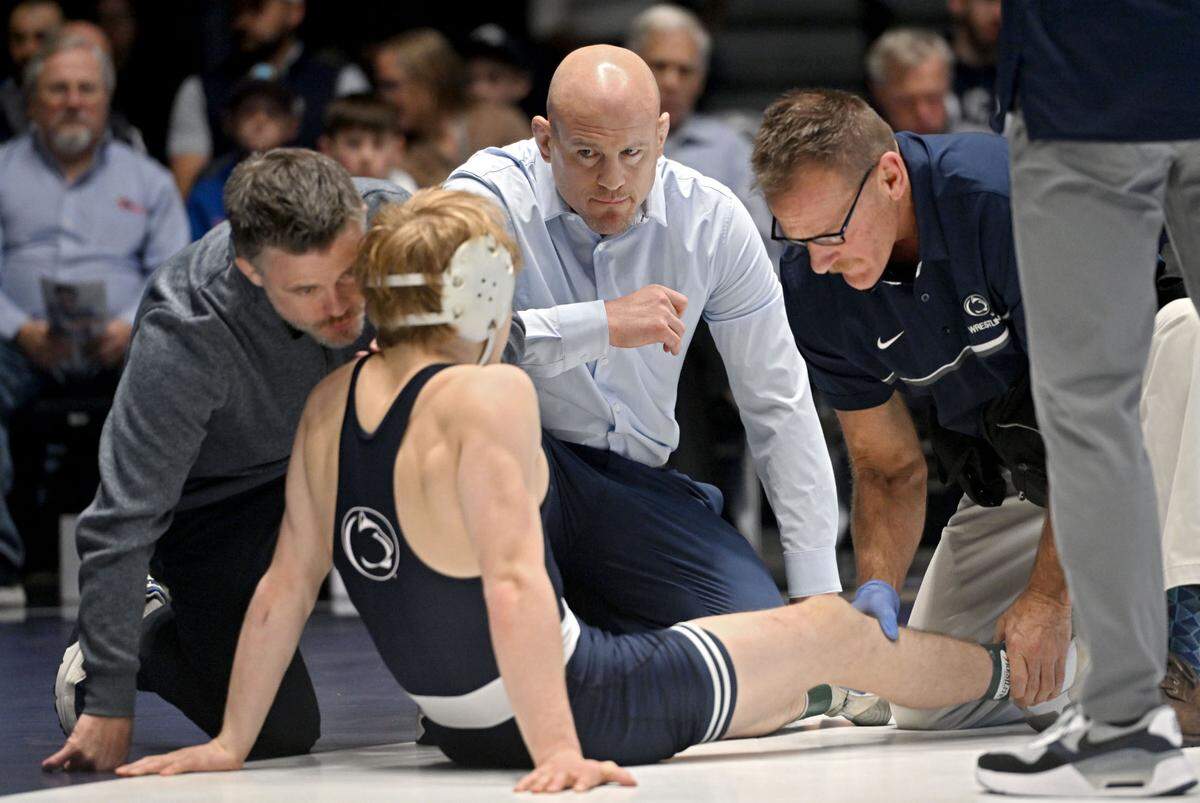 Penn State wrestling coach Cael Sanderson watches Braeden Davis as he is evaluated by the doctor during this 133 lb bout of the match against Drexel on Sunday, Nov. 17, 2024 at Rec Hall.