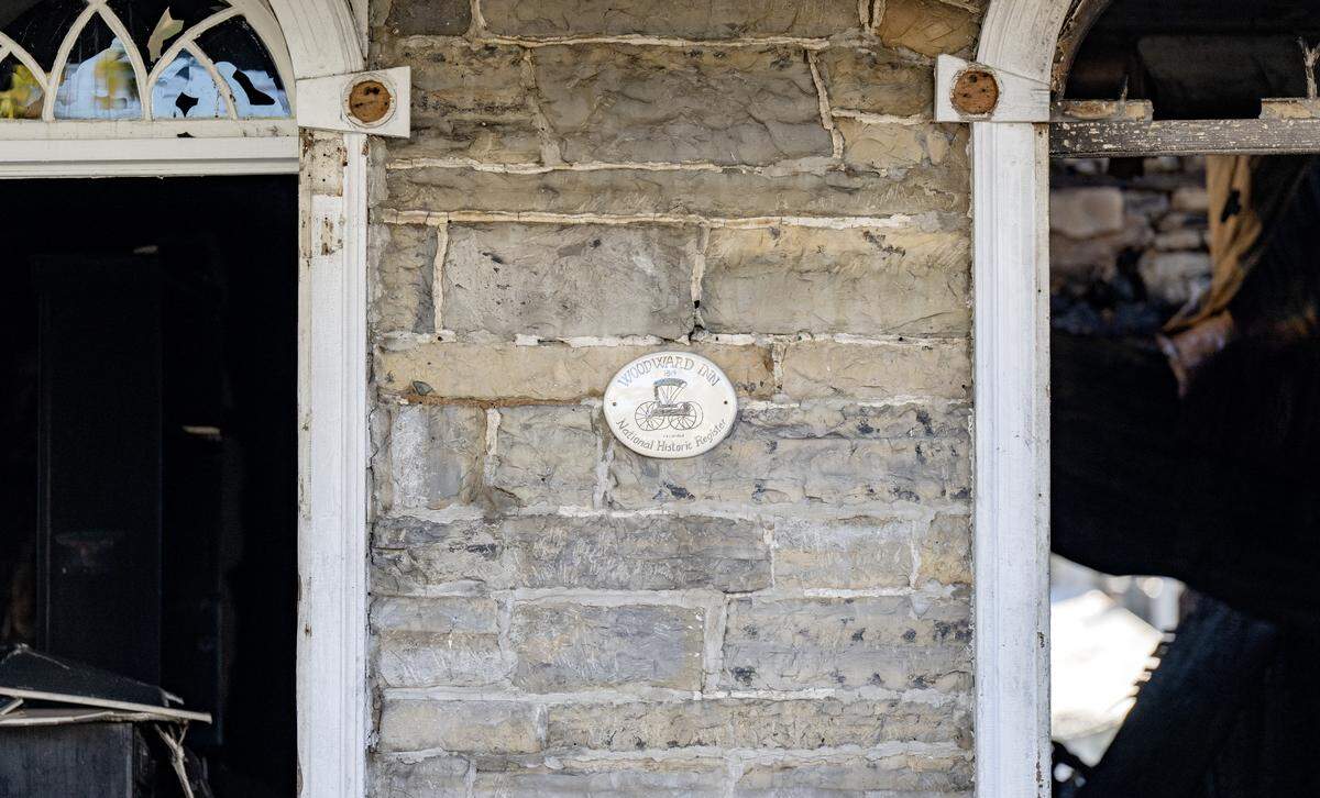 A sign marking the Woodward Inn as a National Historic Register still hangs on the front of the building despite serious fire damage on Monday,Oct. 27, 2025.
