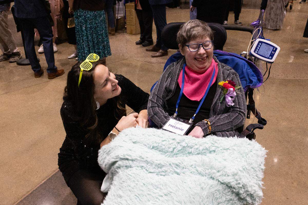 Guests laugh together at Night to Shine on Friday, Feb. 7, 2025.