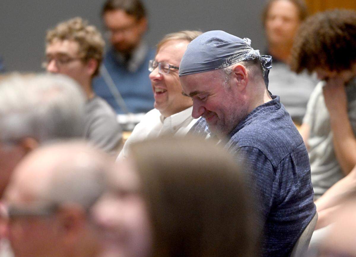 Owners of The Brewery, Jay Horgas and Ray Rockey, laugh as community members share their support and stories about The Brewery during the public comment of the State College Borough Council meeting on Monday, Aug. 21, 2023.