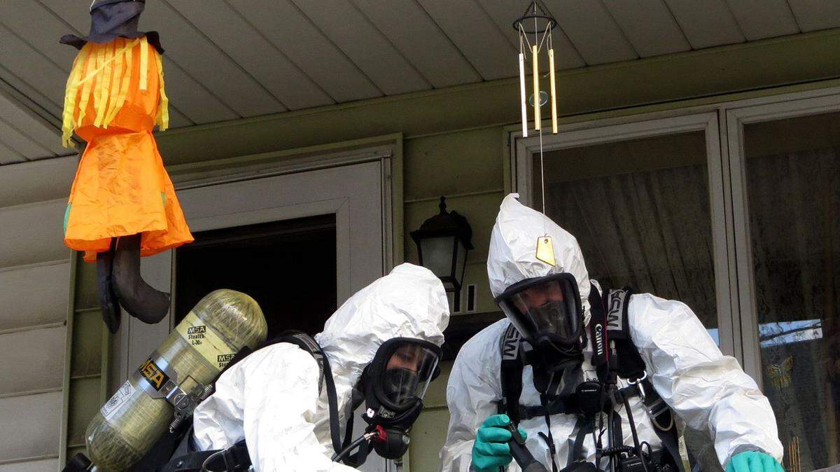 Members of the Pennsylvania State Police Clandestine Lab Response Team remove chemicals from the front porch of a home in Minersville in 2013.
