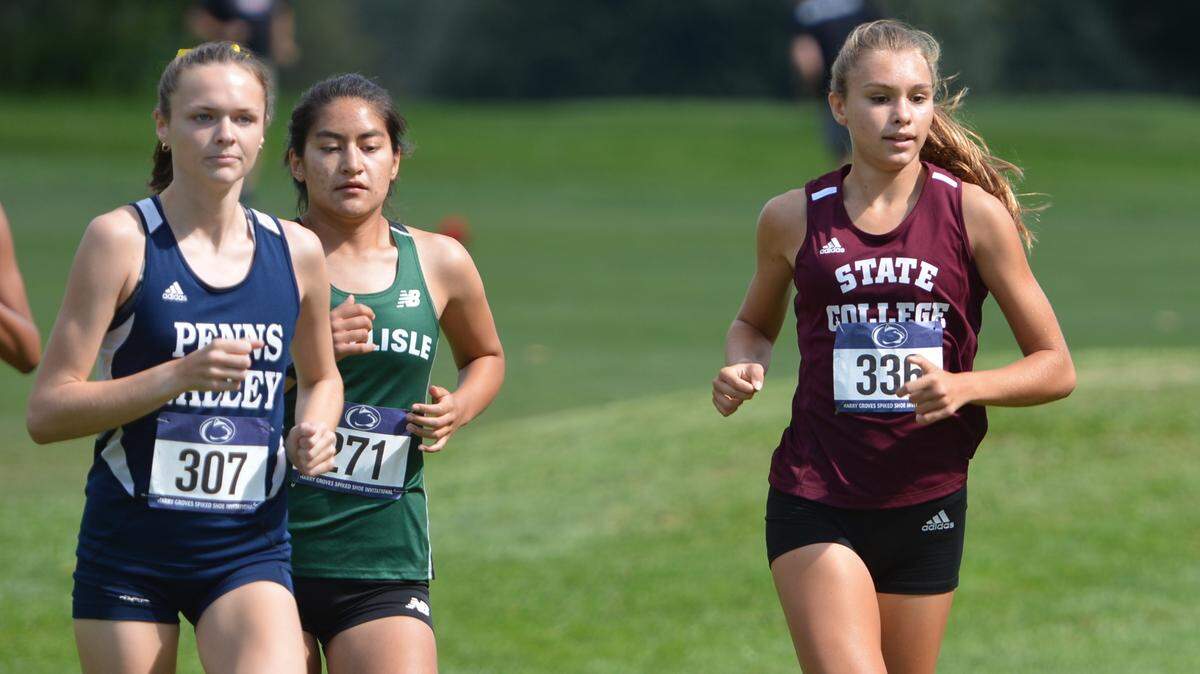 State College’s Marlee Kwasnica, right, finished second and Anna Stitzer, left, finished sixth at the Harry Groves Spiked Shoe Invitational at Penn State on Friday, Sept. 10, 2021. Carlisle’s Vanessa Alder, middle, placed first.