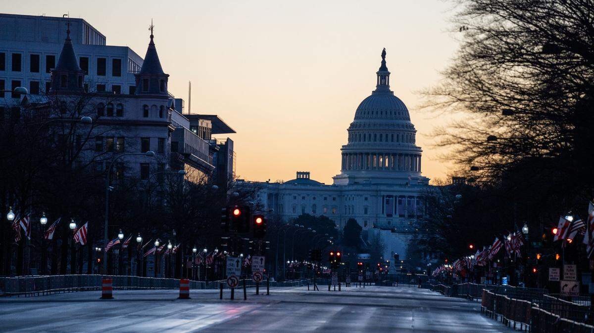 The sun rises behind the U.S. Capitol Building, seen from Pennsylvania Avenue in Washington, D.C.
