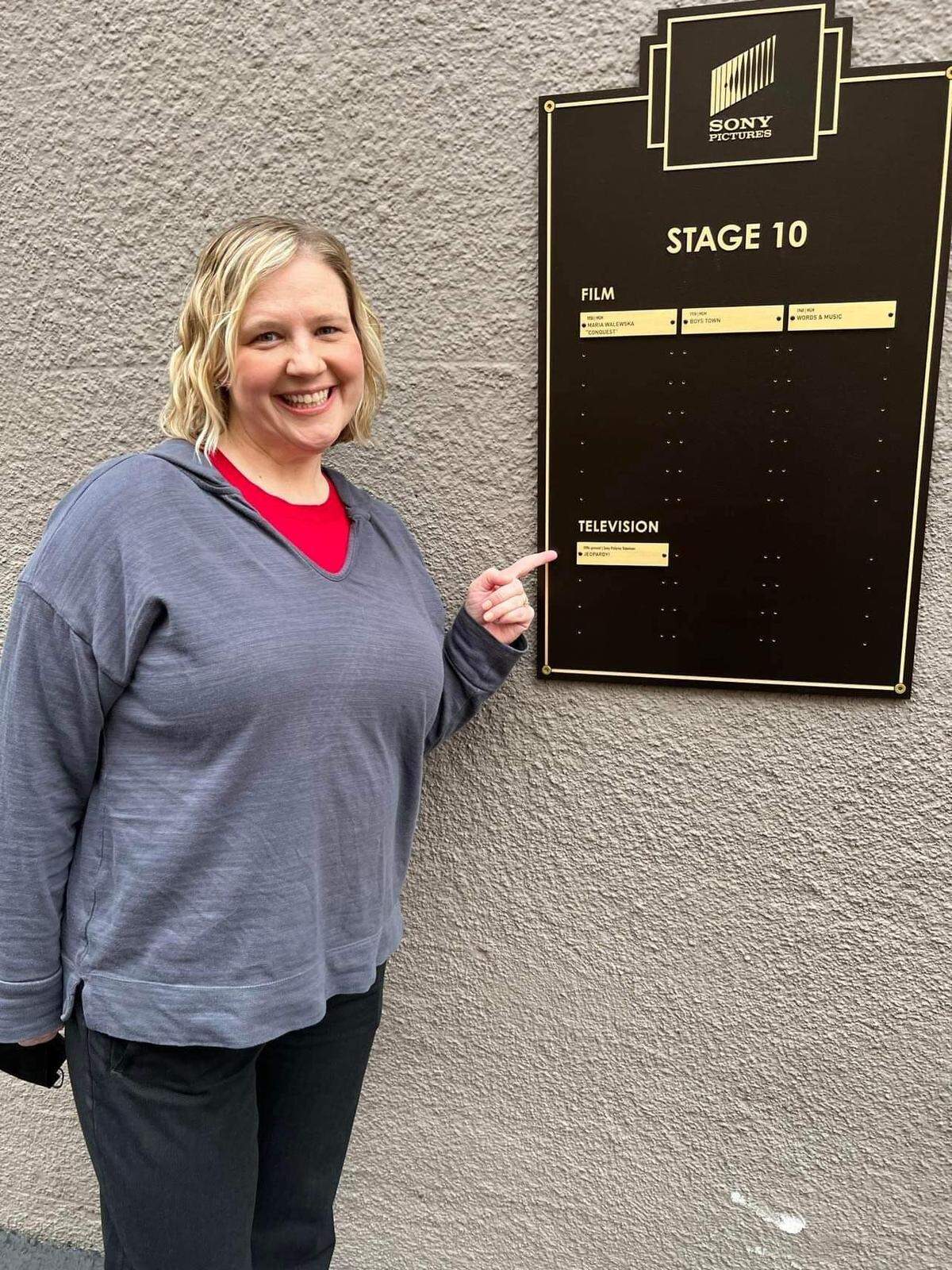 Kendra Westerhaus points to the stage sign when she taped “Jeopardy!” The show is taped at Sony Pictures Studios’ Stage 10 in Culver City, California.
