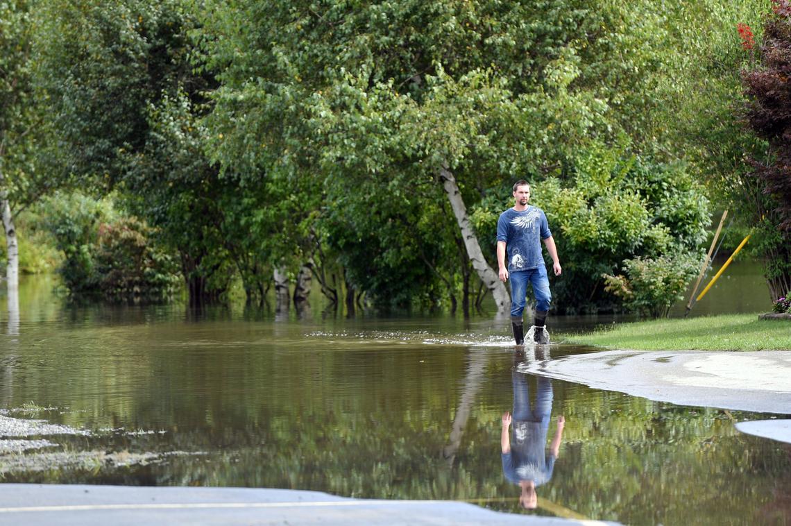 Michael Wayland walks through water on Logan Street on Tuesday, Sept. 11, 2018 in Osceola Mills.