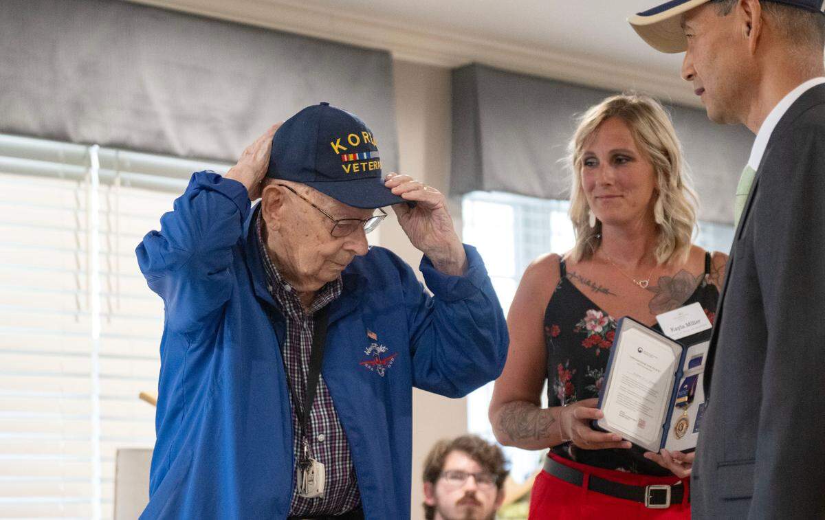 Richard “Dick” Singer adjusted his Korea veteran hat before being presented the Ambassador of Peace Medal by Ben Chon at Celebration Villa of Nittany Valley on Friday, July 18, 2025.