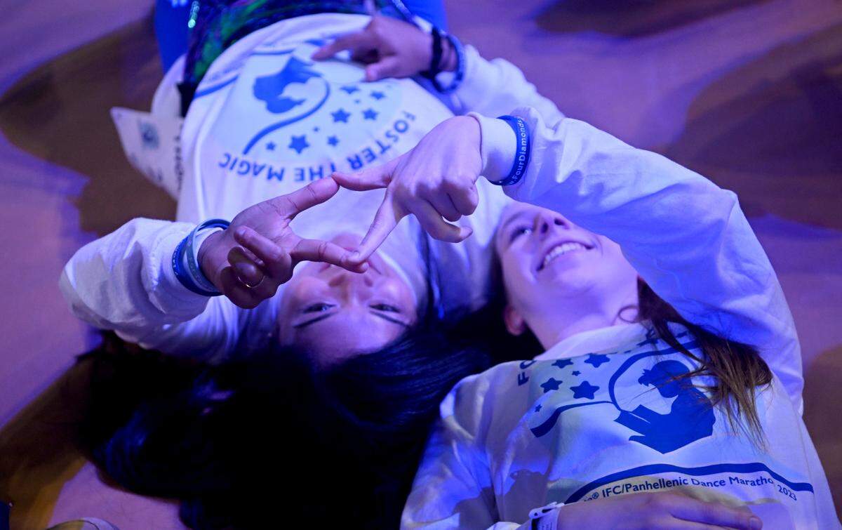 Anushka Mohapatra and Megan Caputo make a diamond as they wait for the stand up for the 46 hour Penn State IFC/Panhellenic Dance Marathon on Friday, Feb. 17, 2023 at the Bryce Jordan Center.