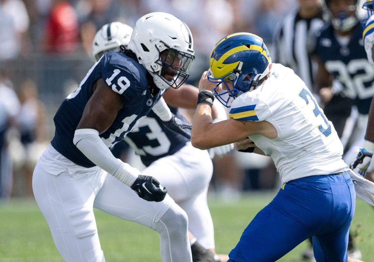 Penn State defensive end Jameial Lyons stops Delaware quarterback Zach Marker during the game on Saturday, Sept. 9, 2023.