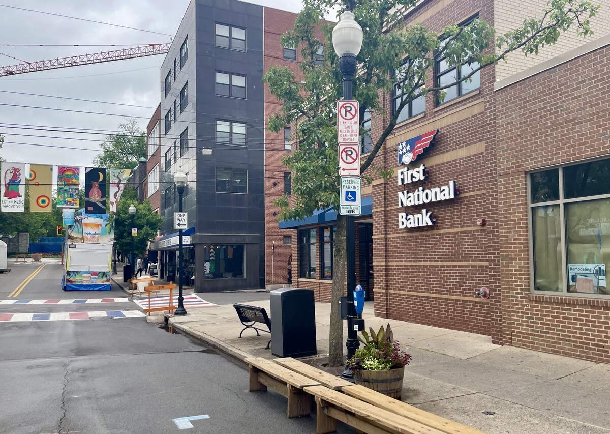 The Peoples National Bank clock has been removed from the sidewalk in front of the First National Bank at 117 S. Allen St. as crews set up for the Central Pennsylvania Festival of the Arts on July 7, 2026.