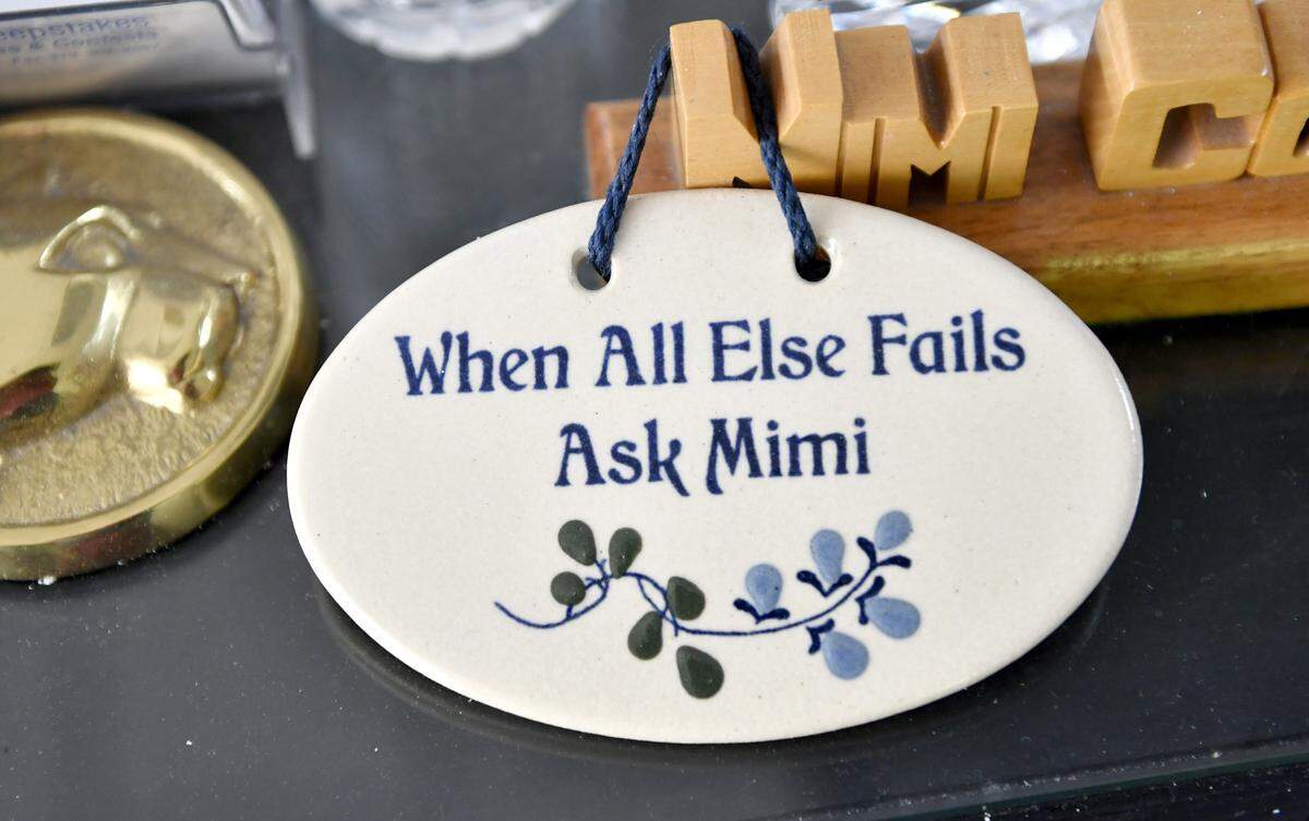 Photos and trinkets are pictured in Mimi Barash Coppersmith’s office in this file photo.