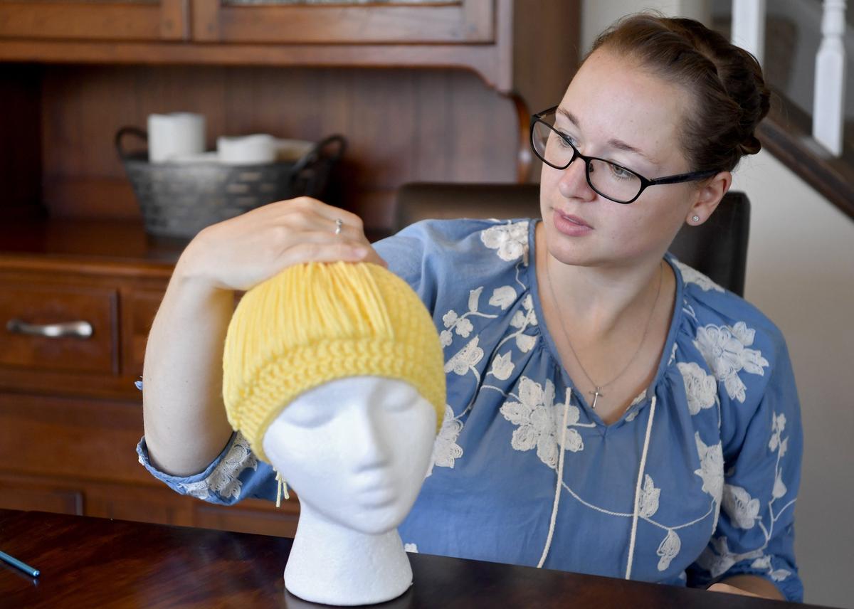 Melissa Wilson shows how she could pull the hair on a beanie into a ponytail on June 3. Wilson said the beanie will become Cinderella, with long hair and a blue headband.
