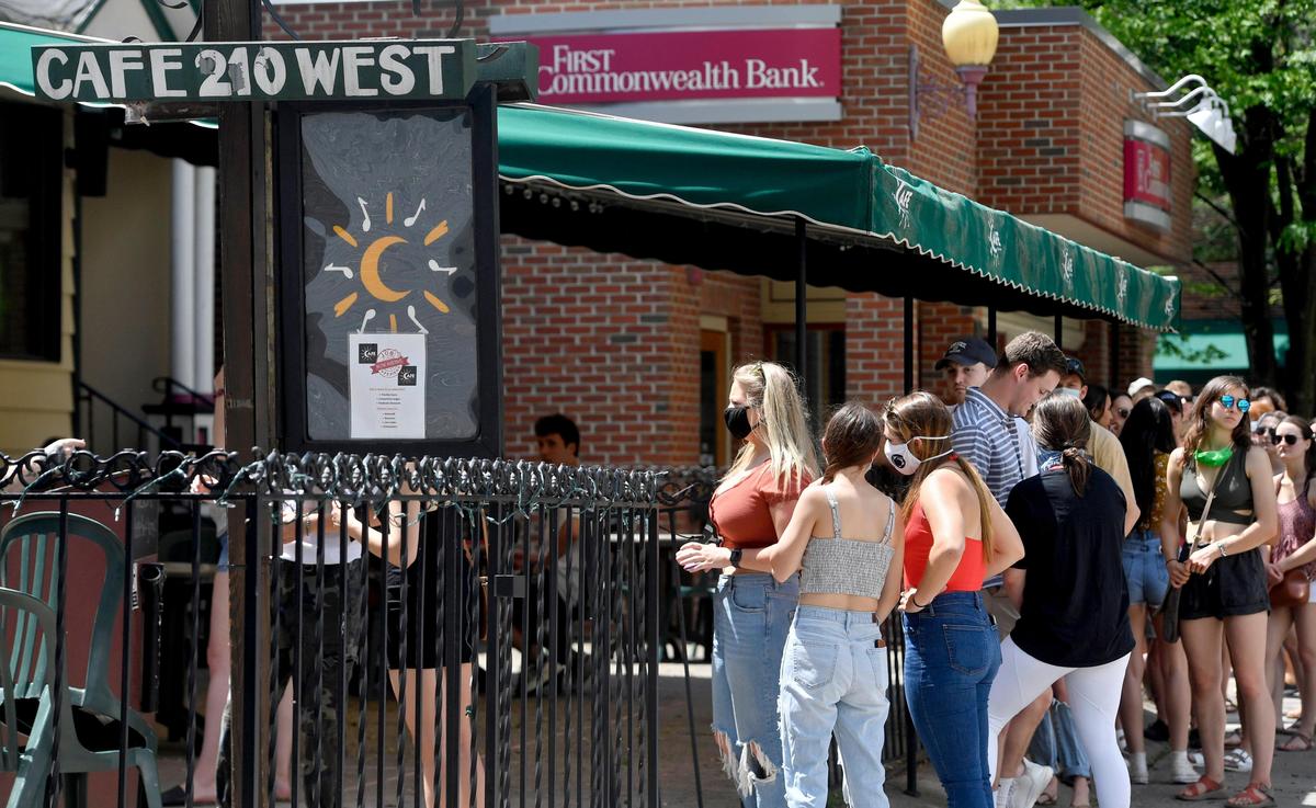 A line of patrons wait to get into Cafe 210 West as they open their doors at noon on Friday, May 29, 2020 for the first time since March.