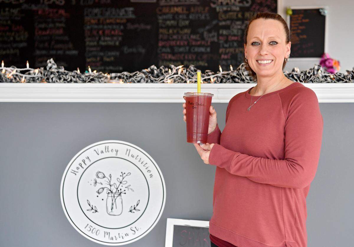 Diane Jozefick, of Happy Valley Nutrition, holds a loaded refresher at the new smoothie and juice shop on Martin Street.