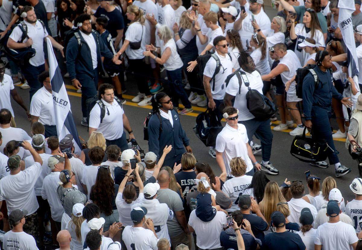 Penn State quarterback Drew Allar leads the team through the fans as they arrive at Beaver Stadium for the game against West Virginia University on Saturday, Sept. 2, 2023.
