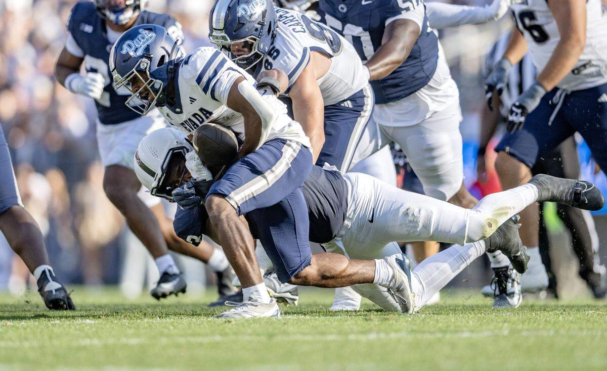 Penn state defensive end Dani Dennis-Sutton knocks the ball away from Nevada running back Herschel Turner during the game on Saturday, Aug. 30, 2025 at Beaver Stadium.