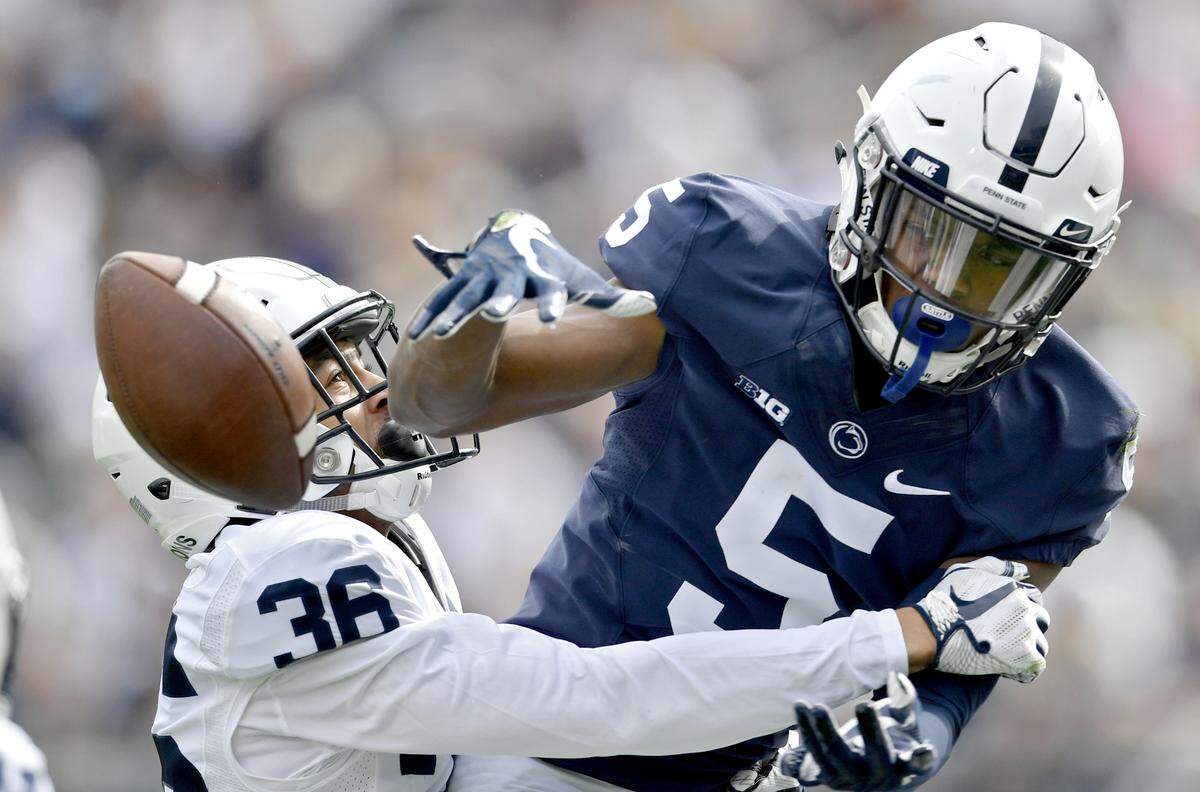 Penn State wide receiver Jahan Dotson misses a catch as he’s blocked by cornerback Makai Self during the Blue-White game on Saturday, April 13, 2019.
