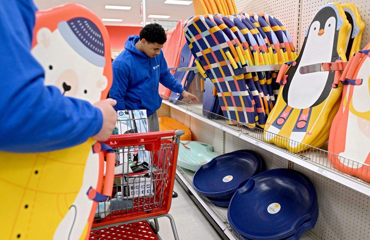 Penn State defensive end Max Granville browses the sleds at Target during the shopping trip for Toys for Tots on Monday, Dec. 2, 2024.