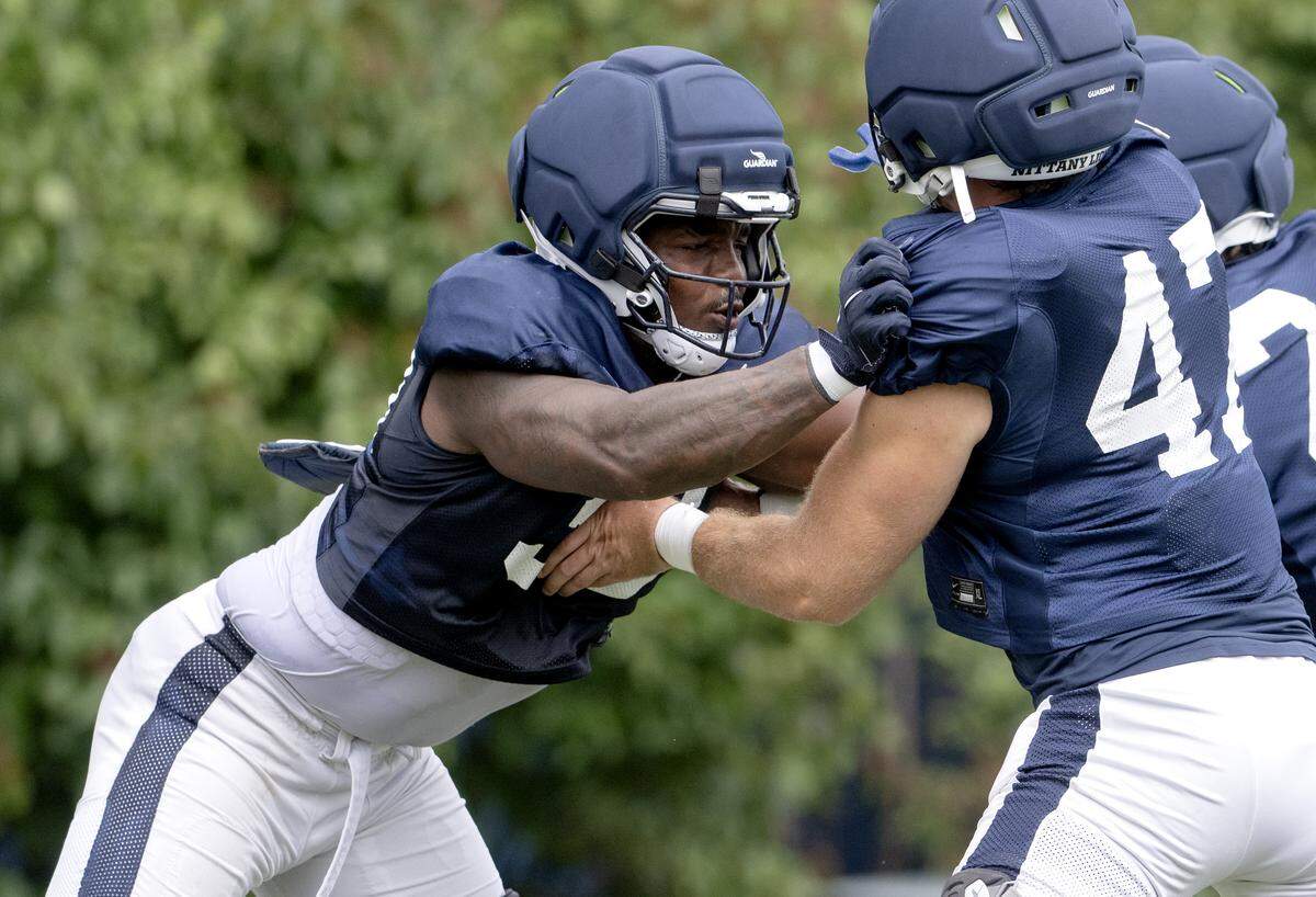 Penn state defensive end Dani Dennis-Sutton pushes into Aidan Probst during a drill at practice on Tuesday, Aug. 19, 2025.  