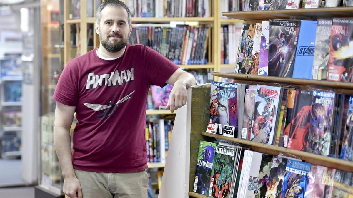 Comic Swap owner John Secreto poses in the shop, located on South Fraser Street.