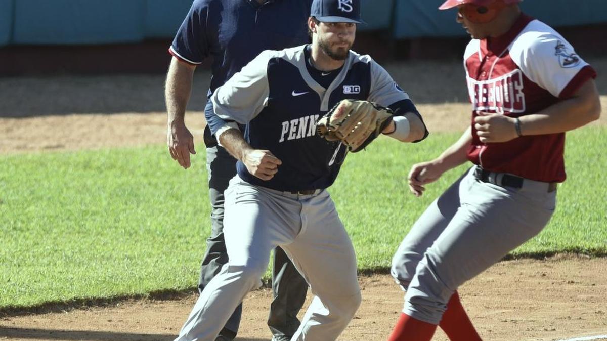 Penn State third baseman Christian Helsel (8) attempts a tag out at third base where Mayabeque right fielder Yansiel Gonzales (14) tries to go first-to-third on a base hit at Nelson Fernandez Stadium in San Jose de Las Lajas, Cuba on Nov. 26.