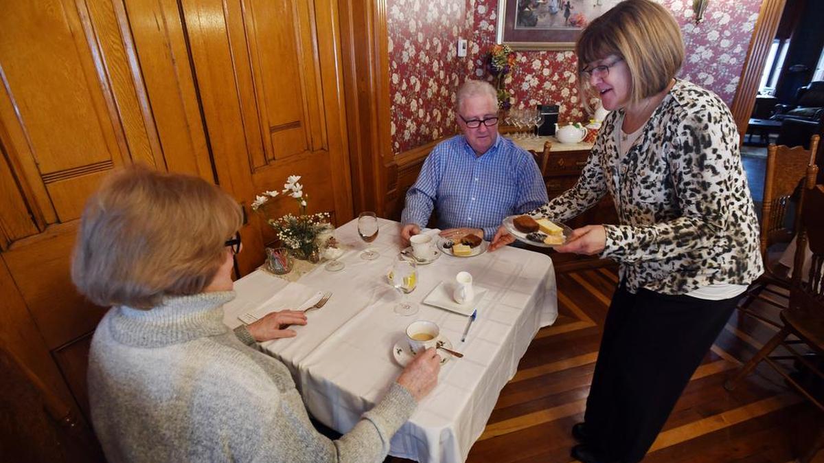Tricia Andriaccio serves Ed and Bea McFadden dessert during Victorian Tea on Feb. 4 at the Reynolds Mansion Bed and Breakfast.
