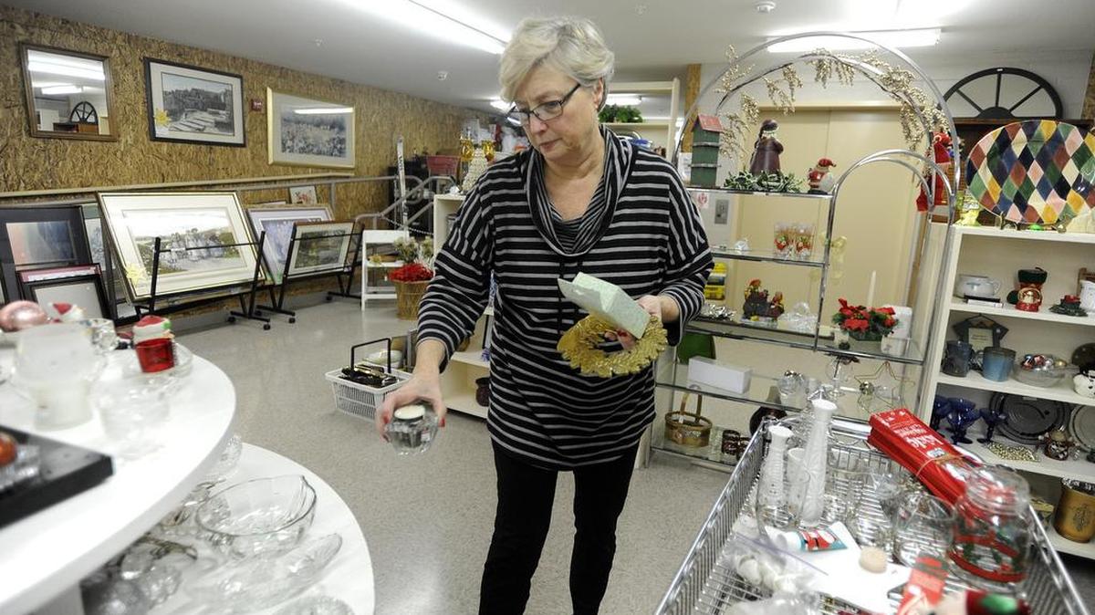 Ginny Clickner, a volunteer, places items on shelves in 2015 at CentrePeace.