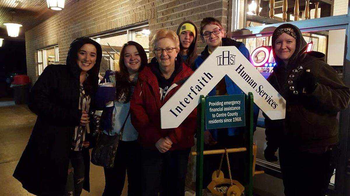 Youth from Park Forest Village United Methodist Church ring bells outside The Corner Room as part of Interfaith Human Service’s Wishing Well campaign.