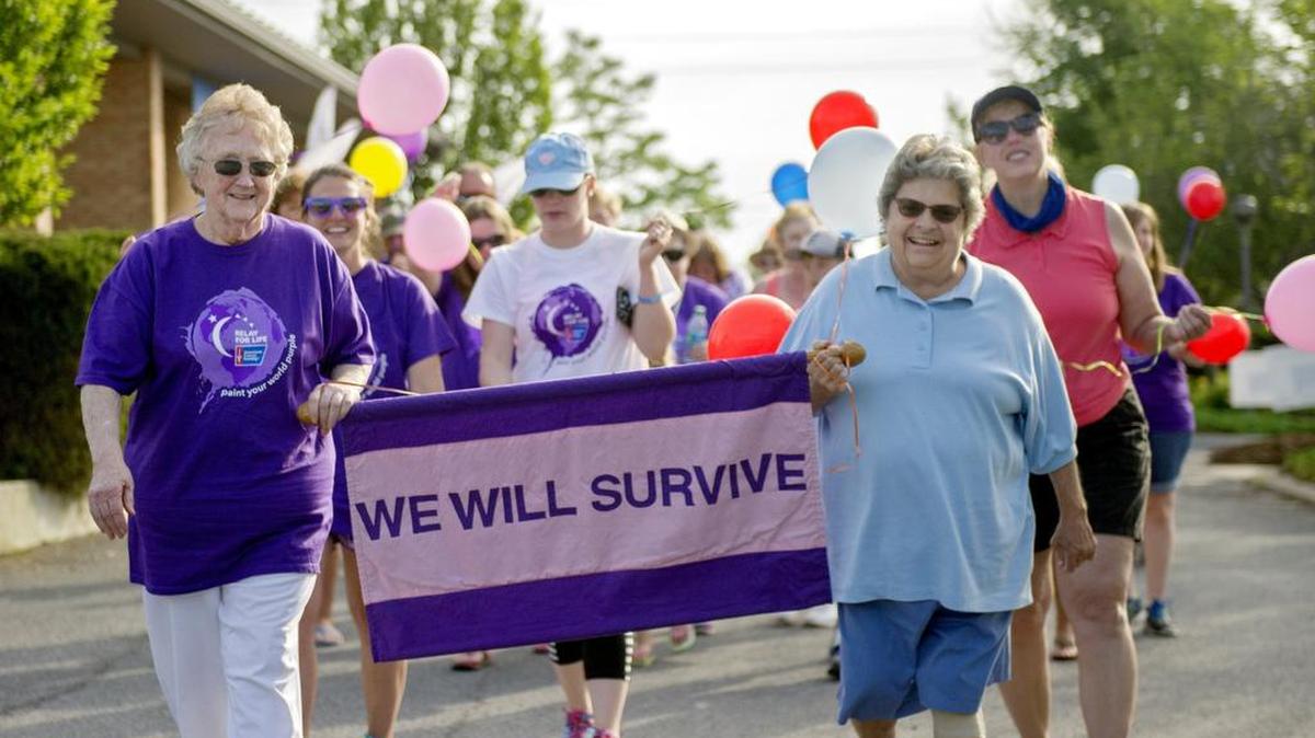 Larue Slother and Gerry McCully laugh together as they lead the survivors lap during the 2016 Relay for Life of the Moshannon Valley.