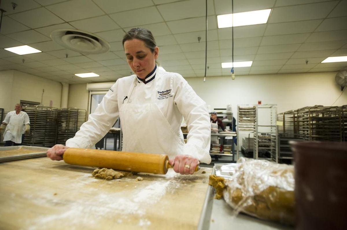 Heather Luse, executive pastry chef at the Penn State Bakery, rolls gingerbread at the bakery in December 2015.