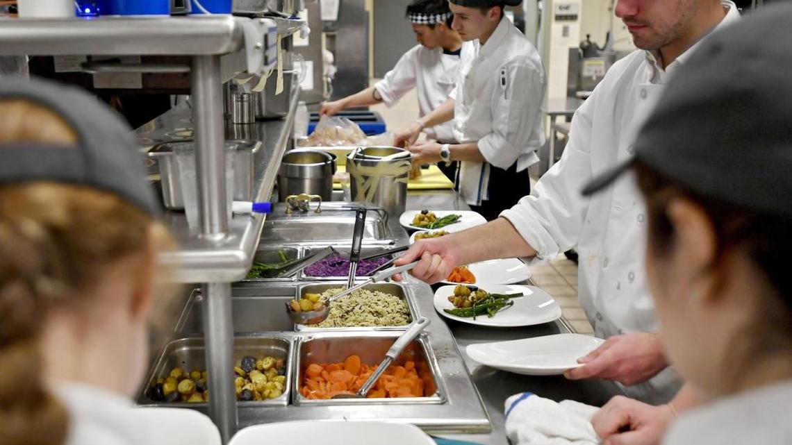 Students chefs plate meals for the April 4 Willy Wonka theme dinner at Cafe Laura.