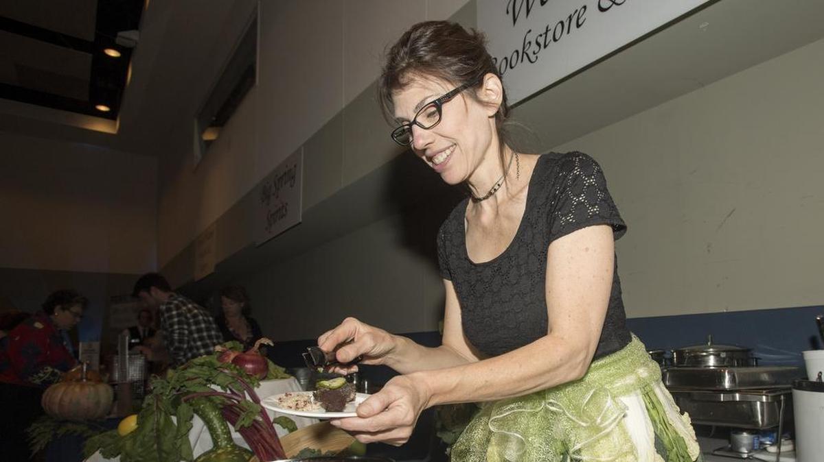 Webster’s Bookstore Cafe owner Elaine Meder-Wilgus prepares a sample during the 2016 Centre County Taste of the Town event at the Penn State Hotel and Conference Center. This year’s event will feature more than 30 vendors.