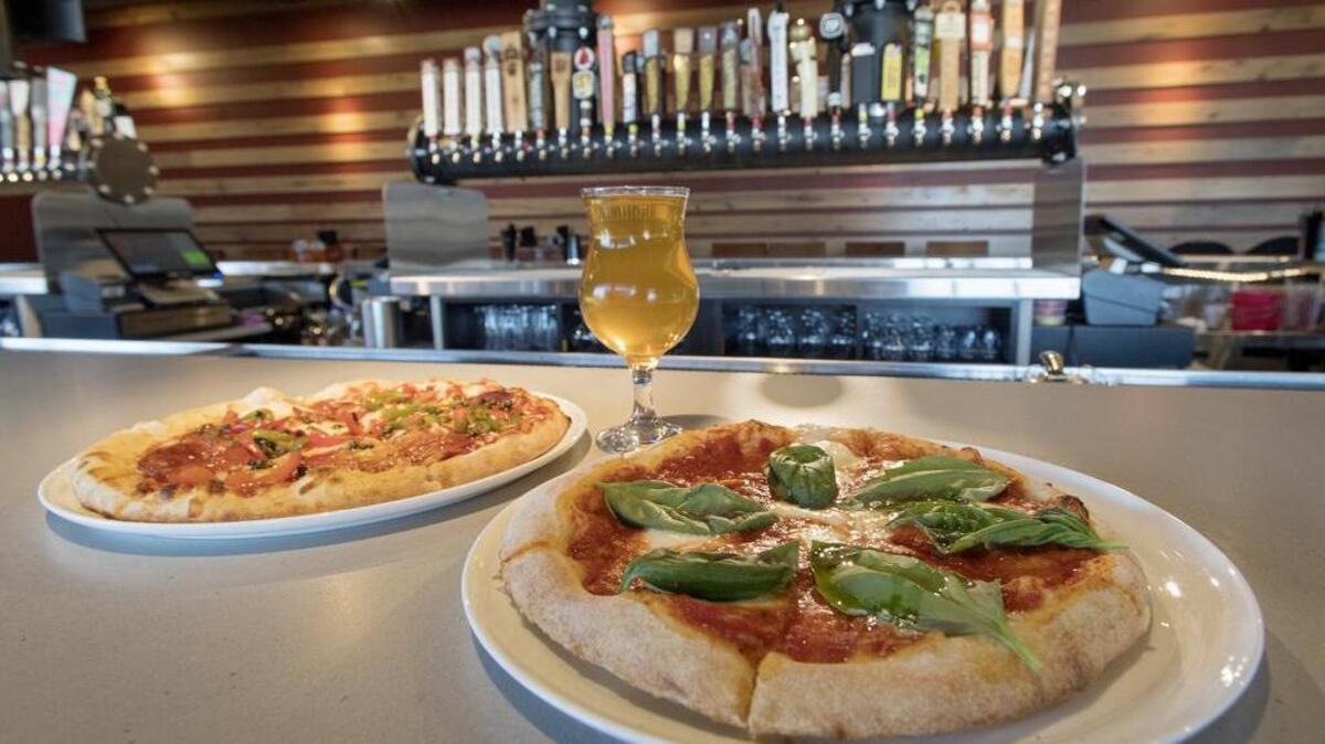 A Margherita pizza, with fresh mozzarella and basil, along with a Founders draft and the Spaniard pizza are served at the Federal Taphouse in the Fraser Center. The Margherita pizza is a top seller.