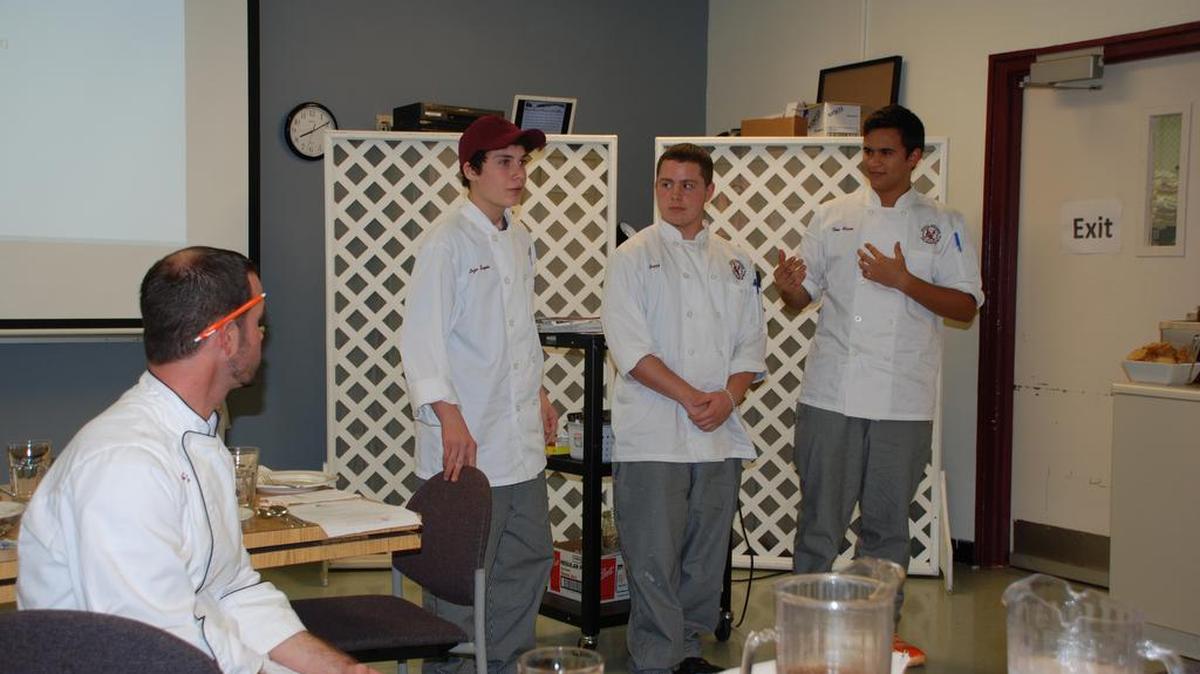 From left: Jeremiah Dick, Enzo Sapia, Noah Keefer and Theo Mason speak on Dec. 14 in Chatter’s Cafe in the State College Area High School.
