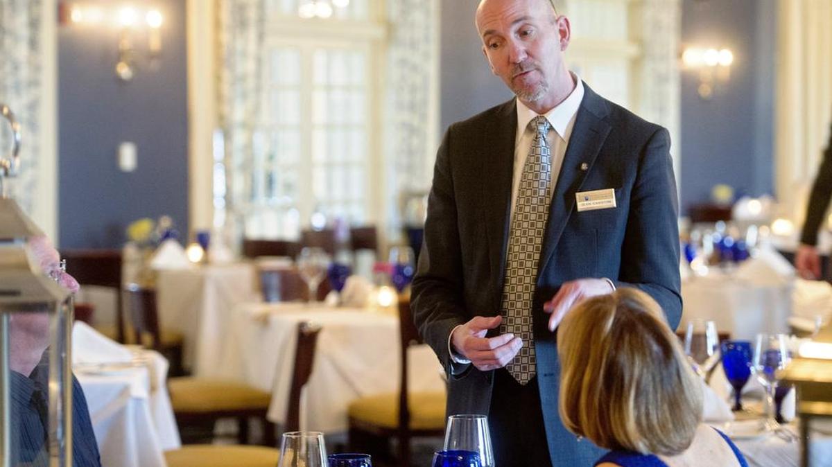 Sean Caviston talks about wine to a pair of diners during Taste of the World Wine Dinner Series at the Nittany Lion Inn in March.