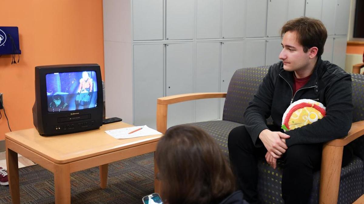 Mike Tartaglia, president of the Penn State Anime Organization, watches an anime movie during Friday Manga Night on Jan. 12 at the HUB-Robeson Center.