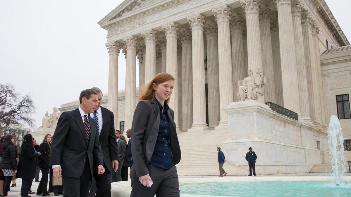 Abigail Fisher, who challenged the use of race in college admissions, walks with lawyers Edward Blum, left, and Bert Rein, rear, outside the Supreme Court in Washington in December 2015.