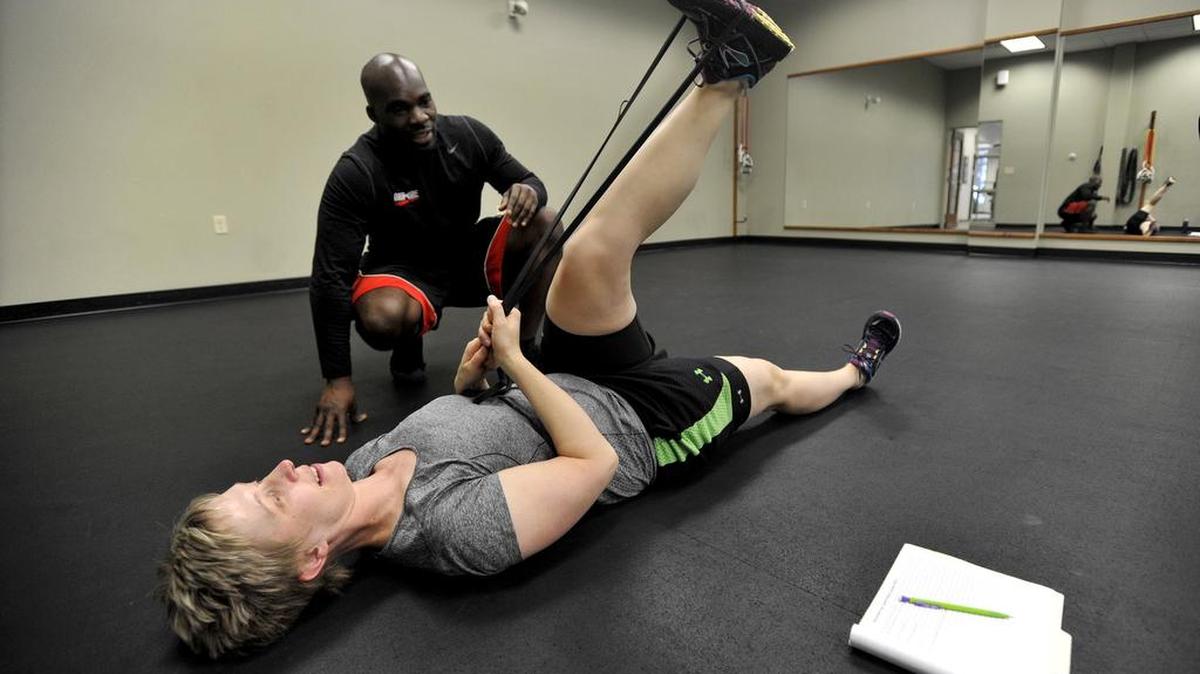 Personal trainer Gbolahan Olaogun works with Sarah Pollock on leg exercises on Wednesday. One on One Fitness Consultants Inc. in State College is located at 424 West Aaron Drive.