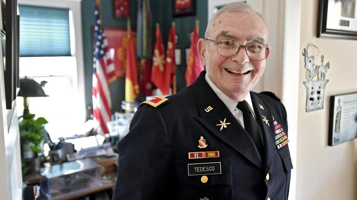 Vincent Tedesco leans in the doorway to his office, which is overflowing with memorabilia from his 27 years in the service. Tedesco has a wing of a the Air Defense Artillery School in Fort Sill Oklahoma named after him, and a road at Fort Hood Texas.
